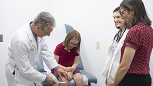 White labcoat with stethoscope on a hanger.