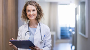 Female doctor reviewing patient chart.