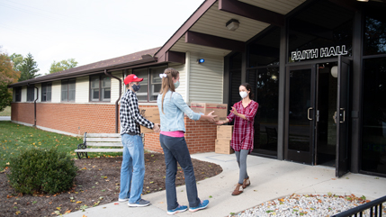 Jonathan and Christie Bitner delivering meals to Faith Hall Residence Director Miriam Olar
