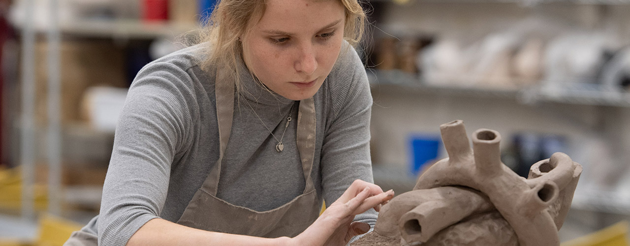 Hannah Stuercke fashioning a heart sculpture