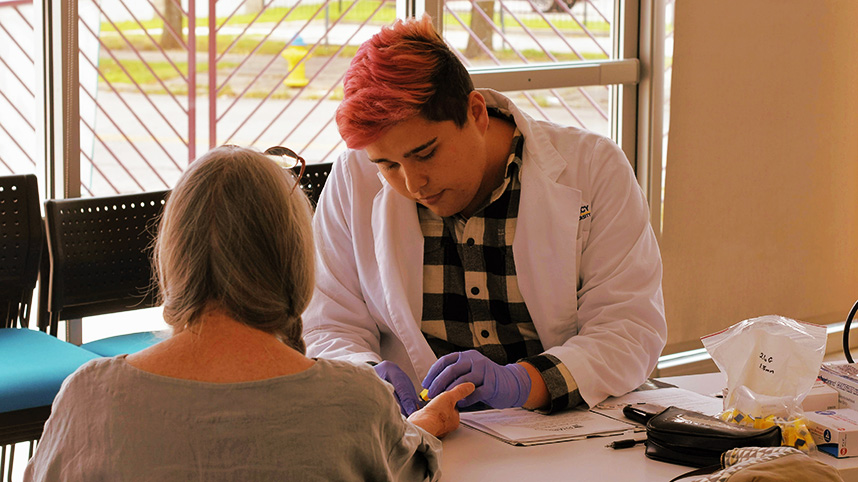 Zach Krauss helping a patient at Gem City Market.
