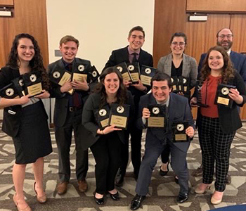 Professor Eric Mishne and the speech and debate team at the Christian college national competition 2022