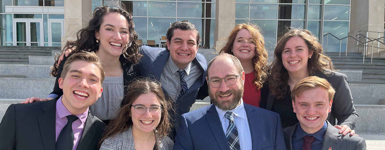 Professor Eric Mishne and the speech and debate team at the Christian college national competition 2022