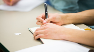 Student writing in a notebook