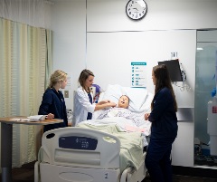 Nursing students working with simulated patient.