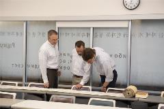 3professorslookingattheTorahScrollonatable