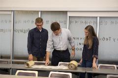 DrShepherdandstudentslookatpartiallyopenedTorahscroll