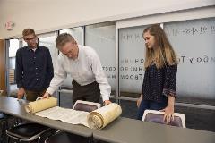 DrMcKinionand2studentsstarttounravelTorahScroll