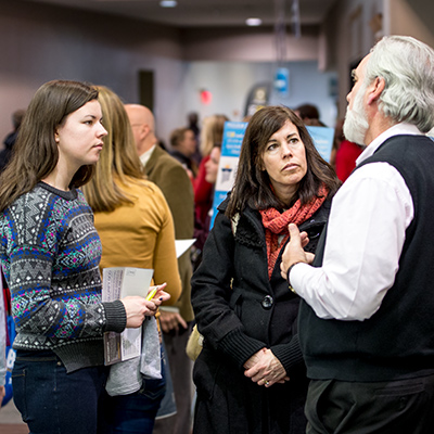 Parent and student talking to a professor